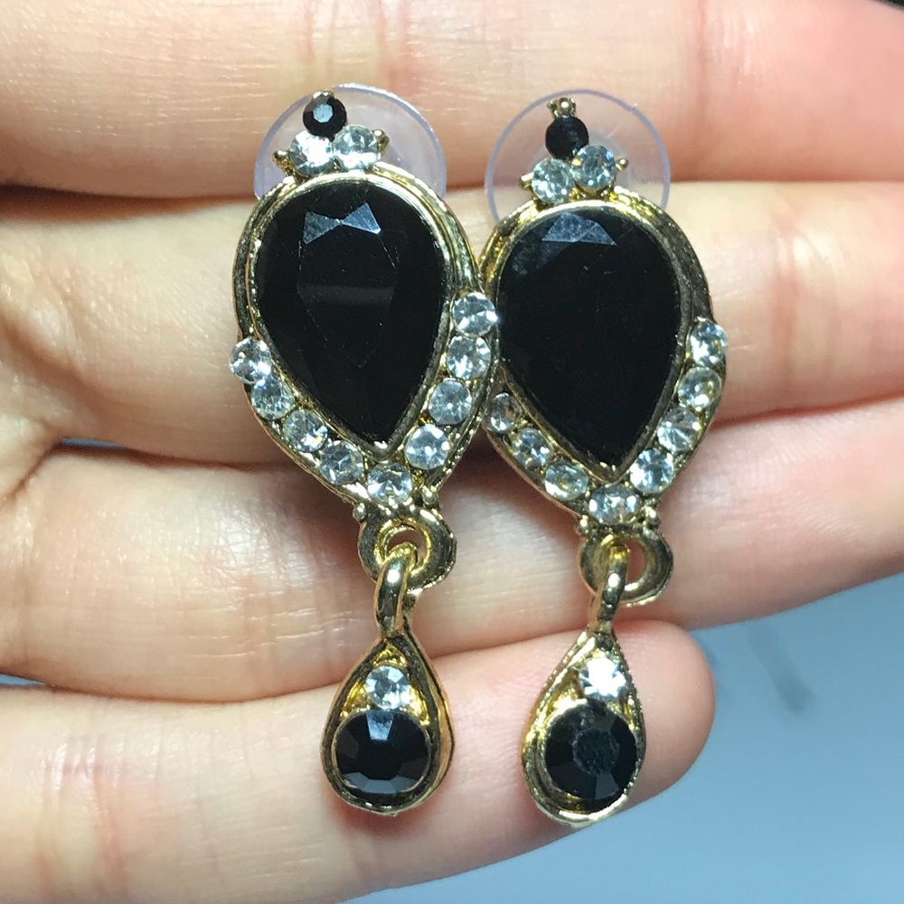 Black stone with silver stones in gold setting